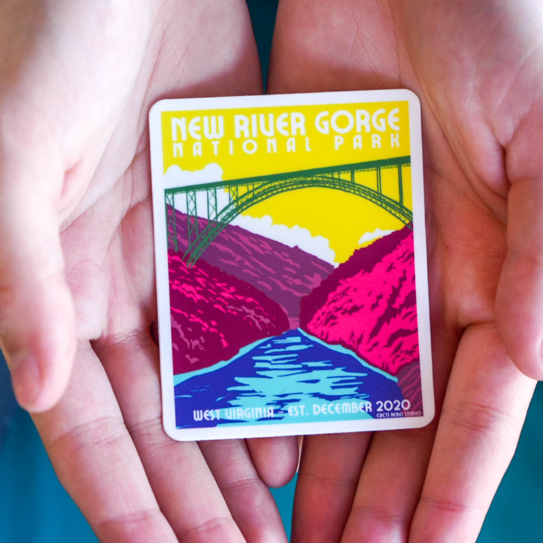 Colorful New River Gorge National Park sticker held between two hands