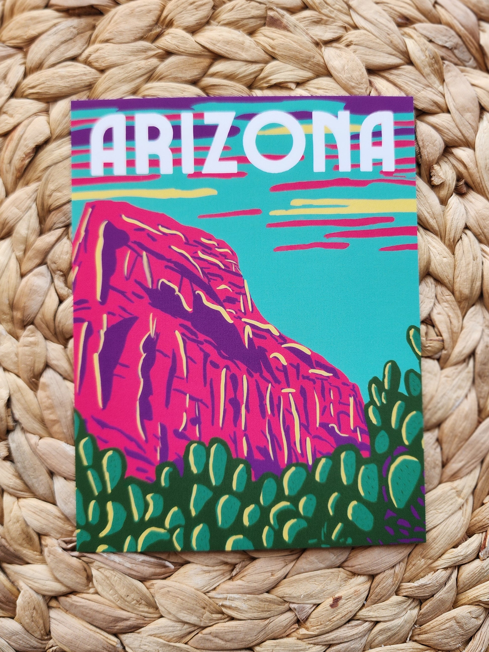 Arizona Postcard with blue sky neon purple pink and yellow clouds and hot pink rock with green cactus'