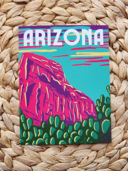 Arizona Postcard with blue sky neon purple pink and yellow clouds and hot pink rock with green cactus'