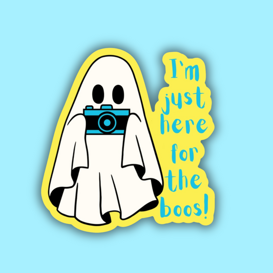 Ghost with a camera and text 'I'm just here for the boos!' on a light blue background