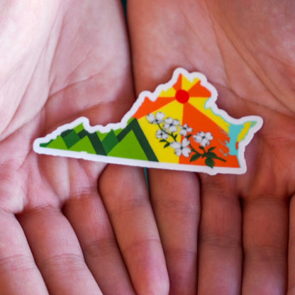 Colorful Kentucky-shaped sticker held in two hands