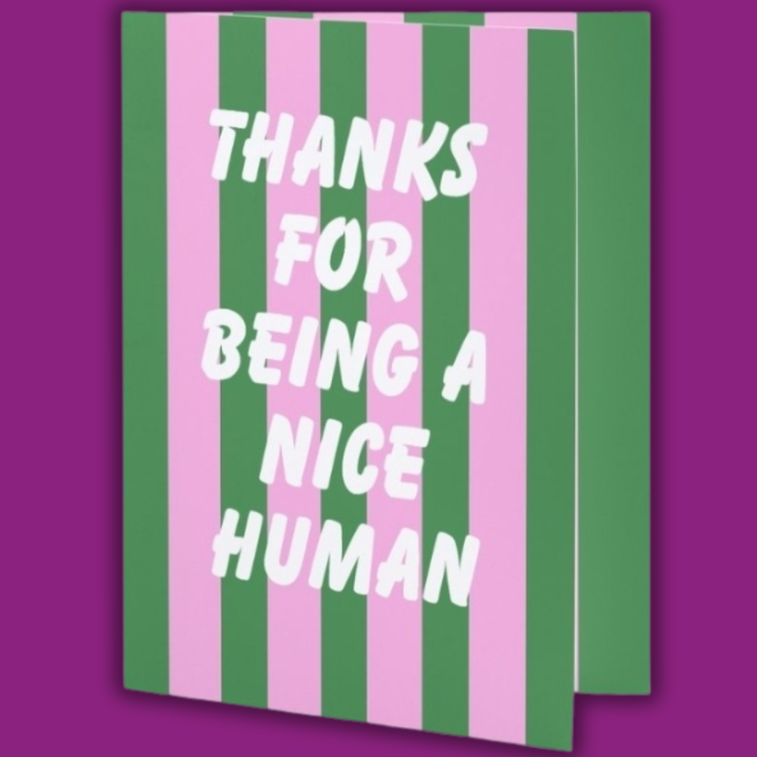 Notebook with green and pink striped cover and 'Thanks for being a nice human' text on a purple background