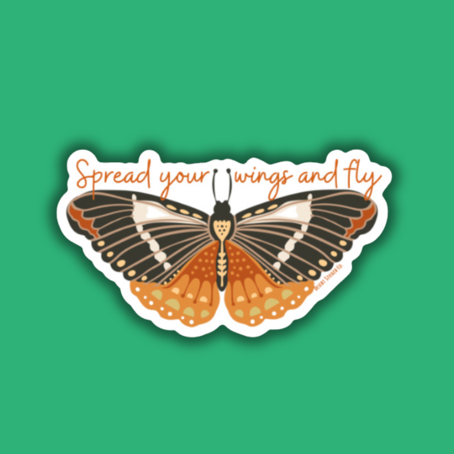 Butterfly sticker with 'Spread your wings and fly' text on a green background