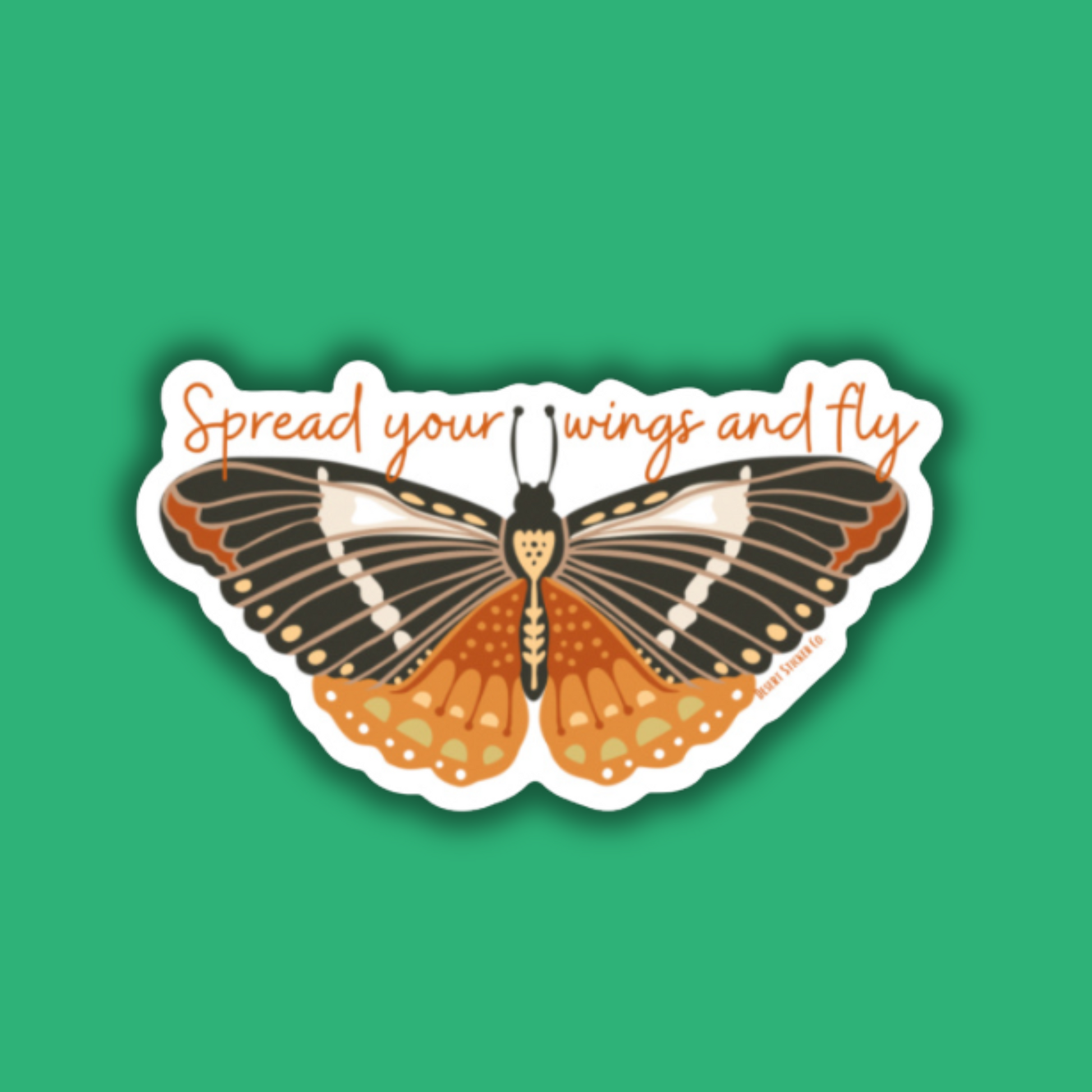 Butterfly sticker with 'Spread your wings and fly' text on a green background